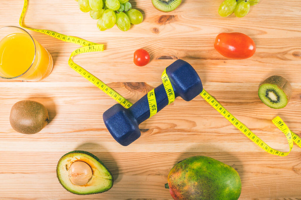 Fitness with dumbbell and genuine food with fruit - Fotoğraf, Görsel