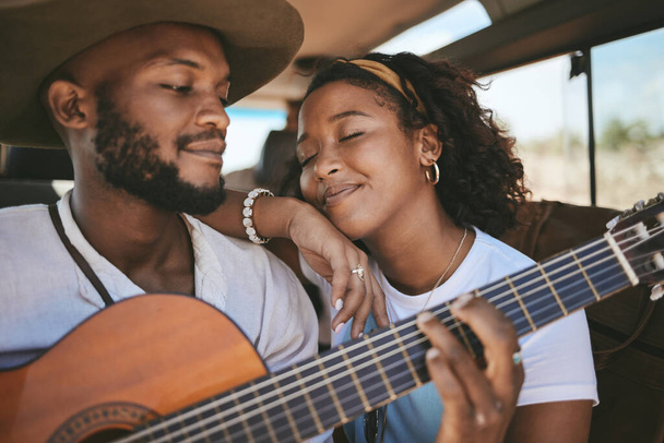 Road trip, guitar music and black couple on drive for adventure and travel on a summer vacation during romantic song moment. Happy man and woman using instrument on motor transport getaway with love. - Photo, Image