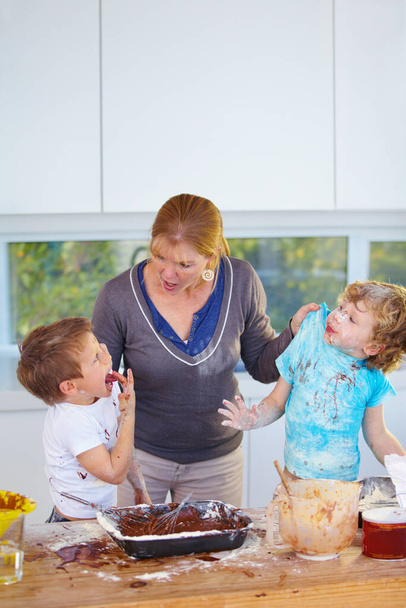 Caught in the act. Two boys being scolded by their mother for messing up her kitchen - Foto, Imagem
