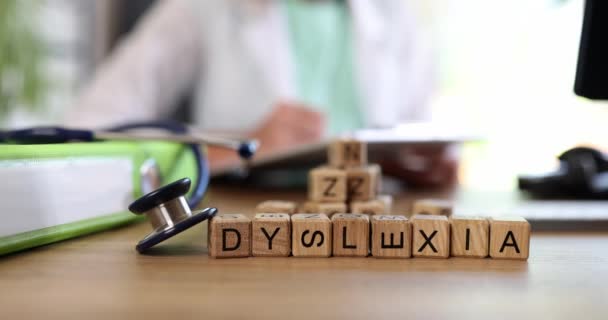 Word dyslexia and doctor writes down diagnosis of dyslexia. Diagnosis and correction of dyslexia - Footage, Video