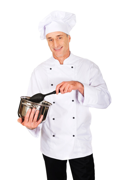 Chef in white uniform mixing his soup - Zdjęcie, obraz