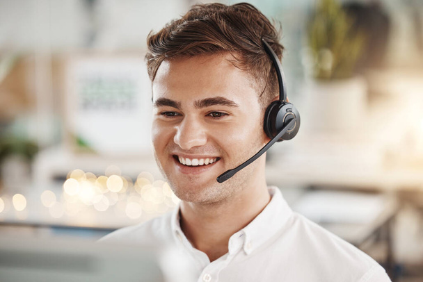 Telemarketing customer support and web help man consultant on an office digital phone call. Happy internet call center worker and agent with headset working on crm contact us tech consulting. - Photo, Image