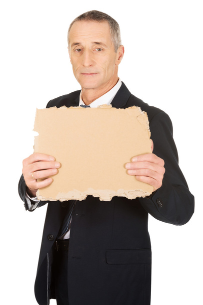 Businessman holding a piece of cardboard - Foto, Imagem