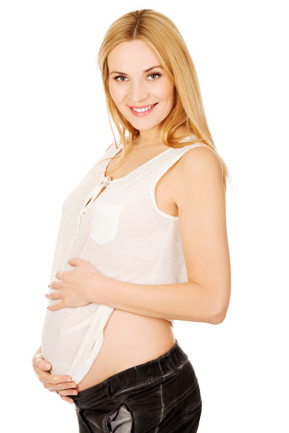 Happy těhotná žena při pohledu na fotoaparát - Fotografie, Obrázek