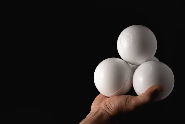 close up portrait of juggling balls, on black background - Photo, Image