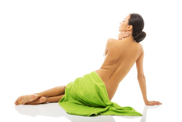Back view woman sitting wrapped in towel - Foto, Imagen