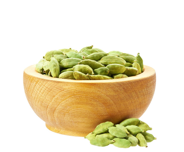Wooden bowl with dry cardamom seeds isolated on white. - Photo, Image