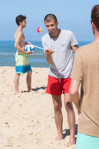 friends playing beach football summer concept - Foto, Bild