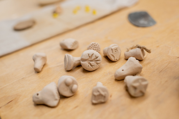 Close up view of clay souvenirs on table in pottery workshop  - Photo, Image