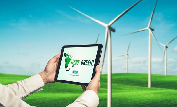 Green business transformation for environment saving and ESG business concept. Businessman using tablet to set corporate goal toward environmental friendly management and alternative clean energy use. - Valokuva, kuva