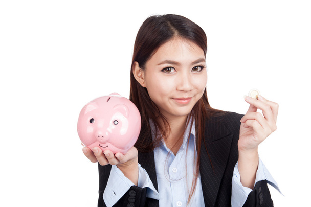 Young Asian businesswoman with a coin and piggy bank - Zdjęcie, obraz
