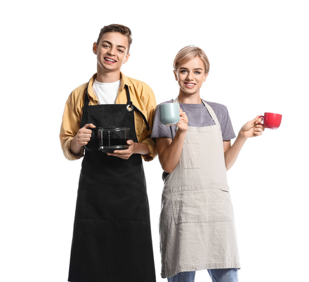 Junge Baristas mit Tassen und Kaffeekanne auf weißem Hintergrund - Foto, Bild