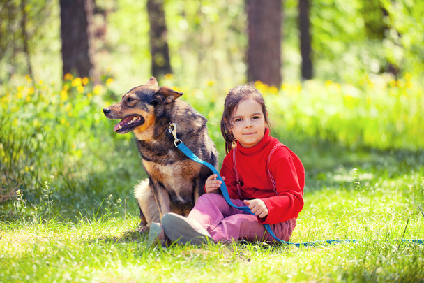 Girl with dog in summer garden - Foto, imagen