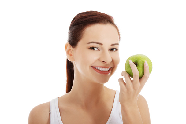Portrait of brunette woman holding an apple - Foto, imagen