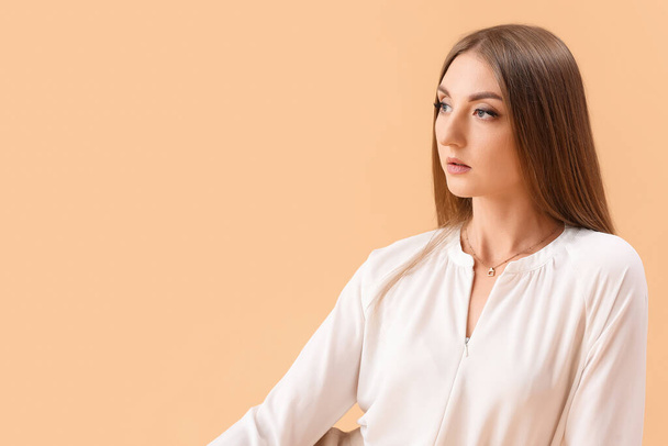 Beautiful elegant young woman on beige background - Photo, Image
