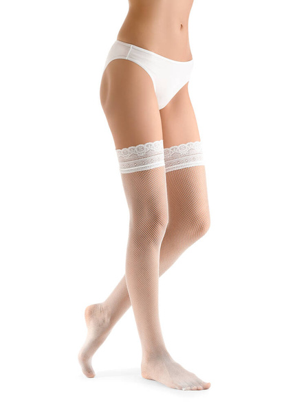 Legs of beautiful young woman in stockings on white background - Fotoğraf, Görsel