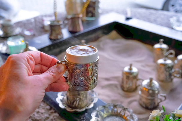 Copper cups with Turkish coffee cooked in hot sand. Travel Turkey. - Photo, Image