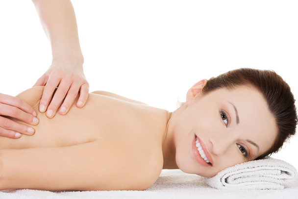 Woman relaxing in spa by getting massage - Photo, image