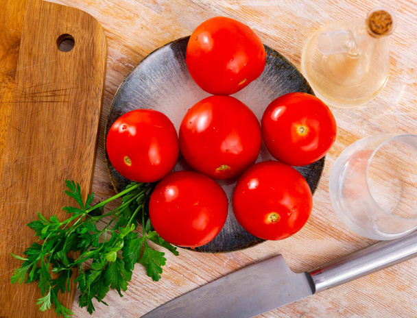 Ripe red tomatoes on wooden background, food preparation - Фото, зображення