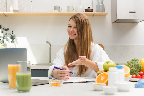 Attractive female nutritionist holding an online consultation with a patient. Healthy food, healthy lifestyle. - Photo, image