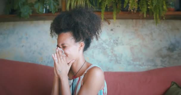 Tiro de uma jovem africana a assoar o nariz na sala de estar. Imagens 4k de alta qualidade - Filmagem, Vídeo