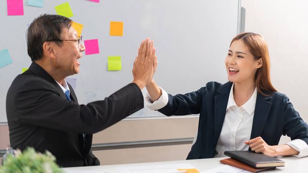 Business partnership concept, Senior in business are giving high five gesture with partner. - Photo, image