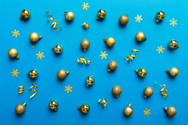 Christmas composition. a pattern of christmas balls on colored background. Flat lay, top view New year decor. - 写真・画像