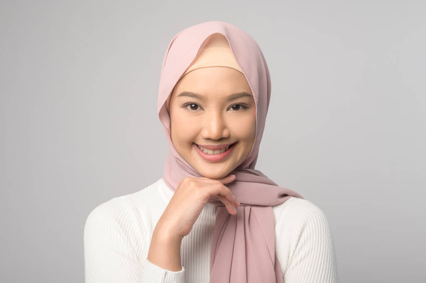 A Portrait of beautiful muslim woman with hijab over white background studio. - Фото, изображение
