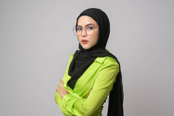 A Beautiful musllim woman with hijab wearing glasses over white background studio, eyecare concept.	 - Fotó, kép