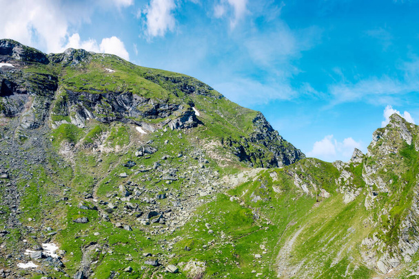 beautiful fagaras ridge on a sunny morning. popular destination in mountain range of romania. rocky cliffs and clouds in morning light. wonderful nature background - Foto, Imagen