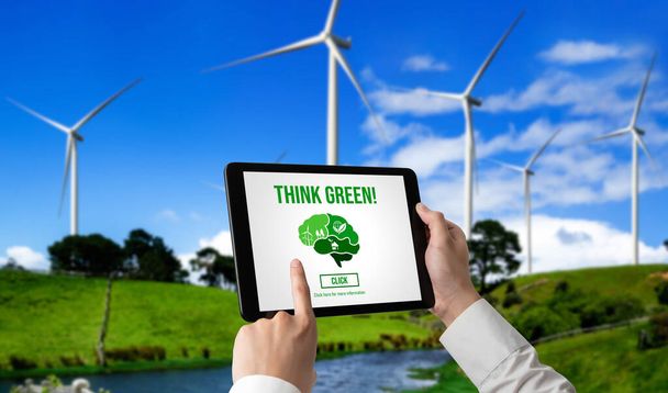 Green business transformation for environment saving and ESG business concept. Businessman using tablet to set corporate goal toward environmental friendly management and alternative clean energy use. - Photo, Image