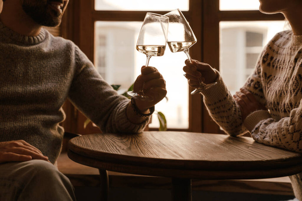 White romantic couple drinking wine during date in cafe indoors - Foto, afbeelding
