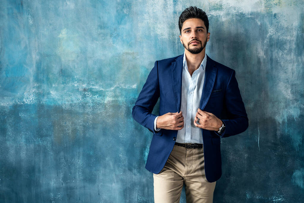 Young handsome businessman posing in elegant fashionable clothes looking at the camera. Portrait of bearded man. A lot of copy space on the background. - Foto, Imagem