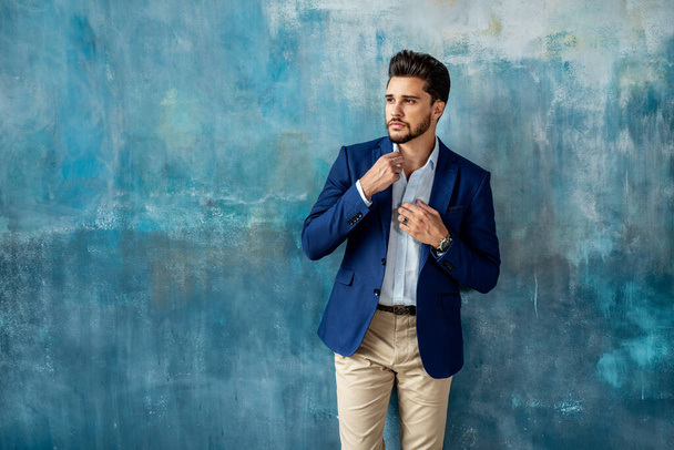 Young handsome businessman posing in elegant fashionable clothes looking away. Portrait of bearded man. A lot of copy space on the background. - Foto, immagini