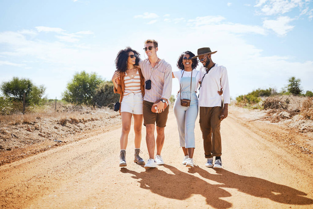 Travel, adventure and friends walk on road path together to explore the Arizona desert in the USA. Bush holiday adventure with diverse friendship and couple group enjoying summer sunshine break - Foto, Bild