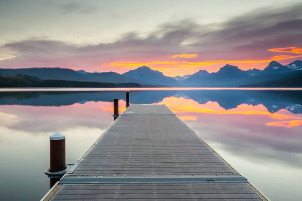 Lake McDonald with a vibrant colorful sunrise in Glacier National Park, Montana, USA - Foto, imagen