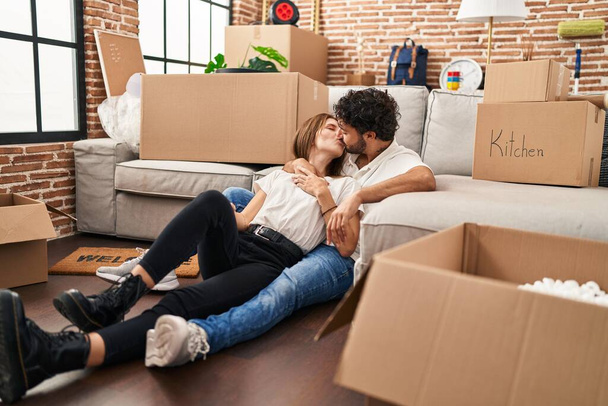 Man and woman couple kissing and hugging each other at new home - Photo, image