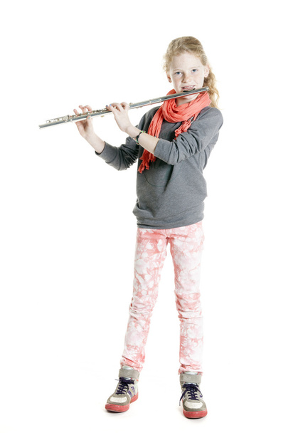 young girl with red hair and freckles plays flute - Photo, image