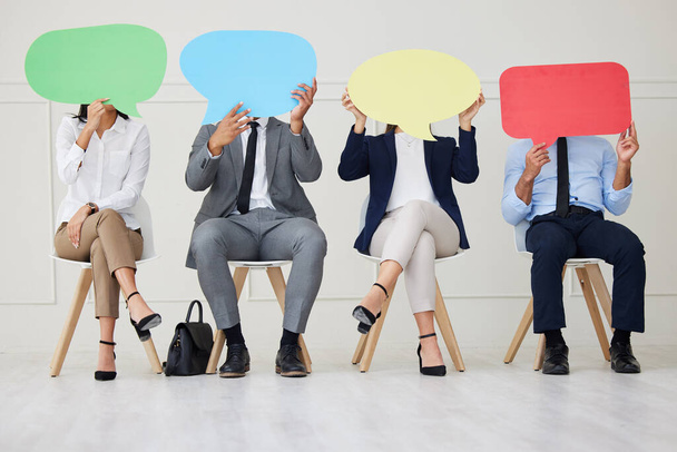 Unknown group of diverse businesspeople holding speech bubble while waiting for interview. Team of applicants together. Candidates in line for job opening, vacancy, office opportunity, unique opinion. - Fotó, kép