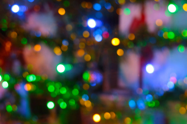Blurry background. Bright lights of a decorated city or spruce - Photo, Image