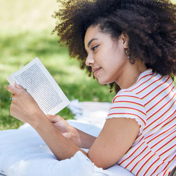 Black woman reading book, relax in park and picnic blanket with novel in nature. Education, learning and female student in Brazil in college or university campus on grass field studying with textbook. - Fotó, kép