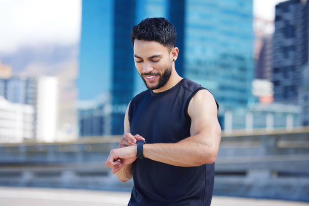 Fitness, happy man and smart watch time for marathon running, exercise workout and healthy urban city training. Sports runner monitor stopwatch, check steps in cardio progress and wellness motivation. - Φωτογραφία, εικόνα