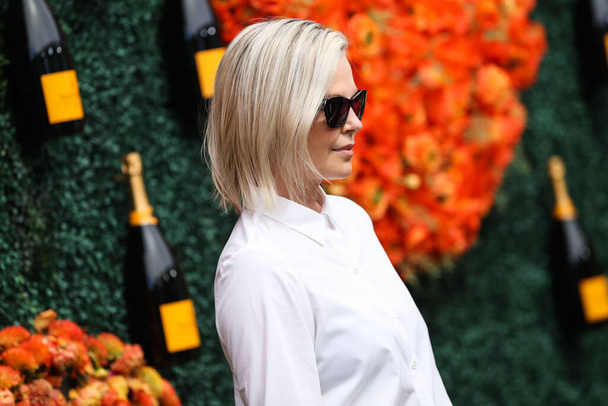 Actress Charlize Theron wearing a ring from Ruchi New York and a Rahaminov Diamonds bracelet arrives at the Veuve Clicquot Polo Classic Los Angeles 2021 held at the Will Rogers State Historic Park on October 2, 2021 in Pacific Palisades, Los Angeles - Photo, Image
