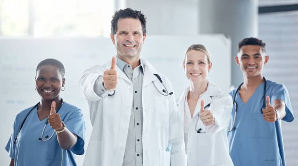 Thumbs up, doctor and happy nurse staff together with success, thank you and welcome hand sign. Portrait of healthcare, medical and health clinic staff smile with a yes, winner and agreement gesture. - Foto, immagini
