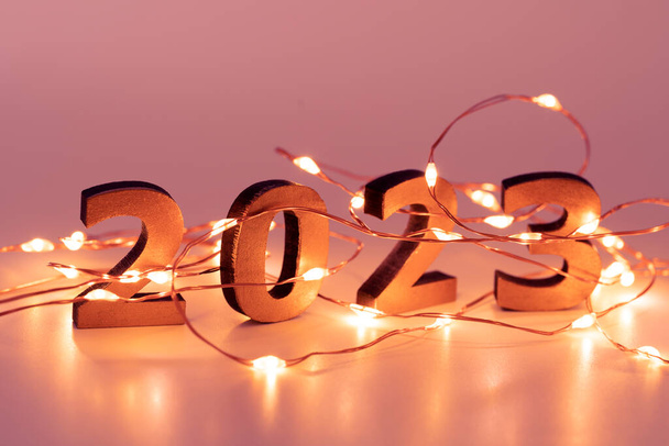 Garland. Christmas lights. Christmas, winter, new year concept. Merry Christmas and Happy New Year. Holiday. Happy New Year 2023 poster. Christmas background with big golden numbers 2023. - Photo, Image