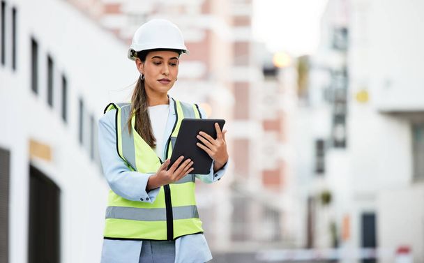 City, digital tablet and woman construction worker with software app for management, site planning and building progress check. Engineer manager in safety gear and 5g technology for urban development. - Photo, image