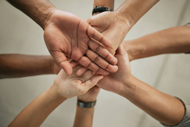 Close up of stacked hands. Group of colleagues putting hands together in the office. Creative team joining hands and showing unity through teamwork. - Fotó, kép