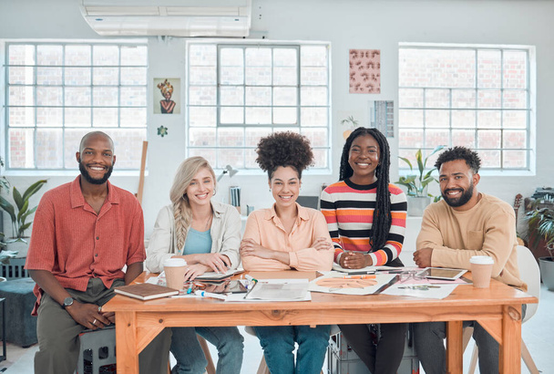 Portrait of a group of happy diverse businesspeople having a meeting in a modern office at work. Cheerful business professionals sitting at a table. Creative businesspeople planning together. - Foto, Imagen