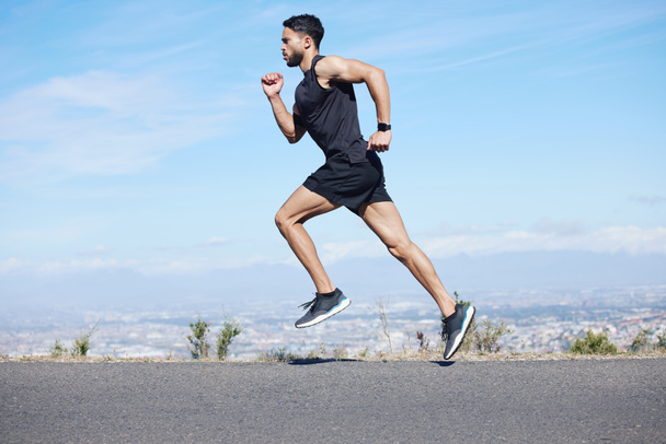 Man running in road, fitness training and run for cardio, health and wellness for healthy lifestyle. Young runner, endurance and sport motivation, fast and fit athlete and exercise journey - Foto, immagini