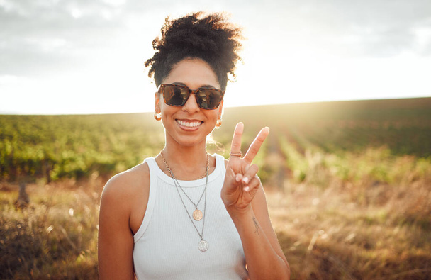 Peace sign, travel and black woman on safari holiday during summer in Kenya. Portrait of a happy, relax and African girl with hand for photo, adventure and happiness on vacation in the countryside. - Fotoğraf, Görsel